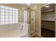 Bathroom features a shower, tub and block window at 3404 E Los Altos Rd, Gilbert, AZ 85297