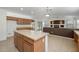 Open kitchen features an island and breakfast bar at 3404 E Los Altos Rd, Gilbert, AZ 85297