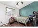 Bedroom with a full-size bed and teal accent wall at 3450 N 67Th Dr, Phoenix, AZ 85033