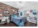 Bright bedroom with wood-look floors, featuring a bed and storage at 3450 N 67Th Dr, Phoenix, AZ 85033