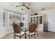 Bright breakfast nook with a glass-top table and four chairs at 3450 N 67Th Dr, Phoenix, AZ 85033