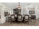 Formal dining room, featuring a large table and statement chandelier at 3450 N 67Th Dr, Phoenix, AZ 85033