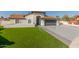 House exterior with a two-car garage and artificial turf at 3450 N 67Th Dr, Phoenix, AZ 85033