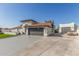 House exterior with a two-car garage and large driveway at 3450 N 67Th Dr, Phoenix, AZ 85033