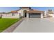 House exterior featuring a two-car garage and nicely landscaped lawn at 3450 N 67Th Dr, Phoenix, AZ 85033