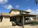 Cozy backyard with covered patio, chairs, and lush green landscaping at 36014 N 3Rd St, Phoenix, AZ 85086