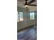 Bright bedroom featuring gray wood-look floors, sliding closet doors, and natural light from a large window at 36014 N 3Rd St, Phoenix, AZ 85086