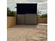 Enclosed storage unit with metal walls and roof, adjacent to a wooden fence, providing secure storage at 36014 N 3Rd St, Phoenix, AZ 85086