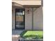 Contemporary front door design with glass panes, neutral stucco, and minimalist porch detail at 36014 N 3Rd St, Phoenix, AZ 85086