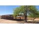 Image features shelter or stables near a large green tree in a sunny setting at 36014 N 3Rd St, Phoenix, AZ 85086