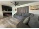 Cozy living room with a gray sectional couch, fireplace, large tv and ceiling fan, perfect for relaxing at 36014 N 3Rd St, Phoenix, AZ 85086