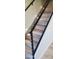 Modern staircase with wood steps and black metal railings, offering a sleek and stylish transition between floors at 36014 N 3Rd St, Phoenix, AZ 85086