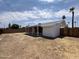 Backyard view of house with covered patio and wood fence at 3748 W Rovey Ave, Phoenix, AZ 85019