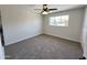 Well-lit bedroom with a ceiling fan and neutral carpet at 3748 W Rovey Ave, Phoenix, AZ 85019