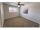 Spacious bedroom with ceiling fan and neutral colored carpet at 3748 W Rovey Ave, Phoenix, AZ 85019