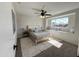 Bright bedroom with a ceiling fan, window seat, and plush carpet at 3748 W Rovey Ave, Phoenix, AZ 85019