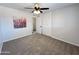 Simple bedroom with ceiling fan, neutral wall paint and carpet at 3748 W Rovey Ave, Phoenix, AZ 85019