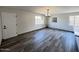 Elegant dining room with wood-look floors and a chandelier at 3748 W Rovey Ave, Phoenix, AZ 85019