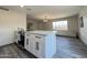 Modern kitchen with white cabinets, quartz countertops, and an island at 3748 W Rovey Ave, Phoenix, AZ 85019