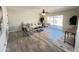 Bright living room with wood-look floors, comfy seating, and sliding glass doors at 3748 W Rovey Ave, Phoenix, AZ 85019