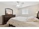 Bedroom with double bed, dark wood dresser, and ceiling fan at 3813 W Glenn Dr, Phoenix, AZ 85051