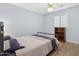 Bedroom with double bed, wooden bookcase, and ceiling fan at 3813 W Glenn Dr, Phoenix, AZ 85051