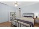 Bedroom with double bed, white shelving unit, and ceiling fan at 3813 W Glenn Dr, Phoenix, AZ 85051