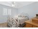 Bright bedroom with a metal bed frame and window shutters at 3813 W Glenn Dr, Phoenix, AZ 85051