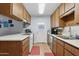 Galley-style kitchen with ample cabinetry and stainless steel appliances at 3813 W Glenn Dr, Phoenix, AZ 85051