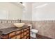 Charming powder room with stone vessel sink and decorative tile at 3883 E Santa Fe Ln, Gilbert, AZ 85297