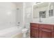 Clean bathroom with tub and shower combo, modern sink, and a big mirror at 3883 E Santa Fe Ln, Gilbert, AZ 85297