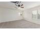 Bright bedroom with neutral carpet, ceiling fan, and white shuttered windows at 3883 E Santa Fe Ln, Gilbert, AZ 85297