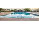 Large community pool with lounge chairs and sun umbrellas available for residents at 3883 E Santa Fe Ln, Gilbert, AZ 85297