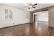 Inviting living room with wood-look floors, ceiling fan, and ample natural light at 3883 E Santa Fe Ln, Gilbert, AZ 85297