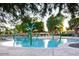 A refreshing pool area featuring whimsical flower-shaped sprinklers and ample lounging space at 3883 E Santa Fe Ln, Gilbert, AZ 85297