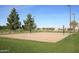 Well-maintained community volleyball court with trees and benches for players and spectators at 3883 E Santa Fe Ln, Gilbert, AZ 85297