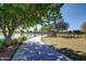 Meandering sidewalk next to lake and mature trees and landscaping at 3883 E Santa Fe Ln, Gilbert, AZ 85297