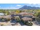 Aerial view of a sprawling estate with a red tile roof and lush landscaping at 4245 E Claremont Ave, Paradise Valley, AZ 85253