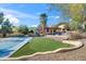 An expansive backyard with a basketball court, putting green, and drought-resistant landscaping at 4245 E Claremont Ave, Paradise Valley, AZ 85253