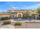 Charming exterior features a tile roof, arched entry and manicured landscaping at 4245 E Claremont Ave, Paradise Valley, AZ 85253