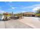 Beautiful home with desert landscaping, a stone address marker, and a circular driveway at 4245 E Claremont Ave, Paradise Valley, AZ 85253