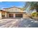 Spacious home featuring a two-car garage and a Spanish tile roof at 4245 E Claremont Ave, Paradise Valley, AZ 85253