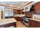 Beautiful kitchen featuring stainless steel appliances, stone countertops, and custom cabinetry at 4245 E Claremont Ave, Paradise Valley, AZ 85253