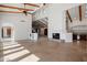 Open living space with stone floors, wood beams, and a cozy fireplace at 4245 E Claremont Ave, Paradise Valley, AZ 85253