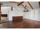 Expansive living room with hardwood floors, chandelier, and a granite-topped wet bar at 4245 E Claremont Ave, Paradise Valley, AZ 85253