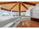 Sunlit loft with hardwood floors, arched windows, built-in shelving, and wood beamed ceiling at 4245 E Claremont Ave, Paradise Valley, AZ 85253