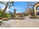 Outdoor patio kitchen area featuring stone accents, desert landscaping, and blue skies at 4245 E Claremont Ave, Paradise Valley, AZ 85253