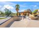 An empty pool featuring stone detail, an outdoor kitchen, desert plants, and blue skies at 4245 E Claremont Ave, Paradise Valley, AZ 85253