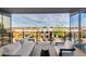 Balcony with seating overlooks a vibrant commercial district offering views of palm trees and distant mountains at 4422 N 75Th St # 3012, Scottsdale, AZ 85251