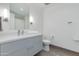 Bright bathroom with a large mirror, modern sink, toilet, and stylish gray flooring at 4422 N 75Th St # 3012, Scottsdale, AZ 85251